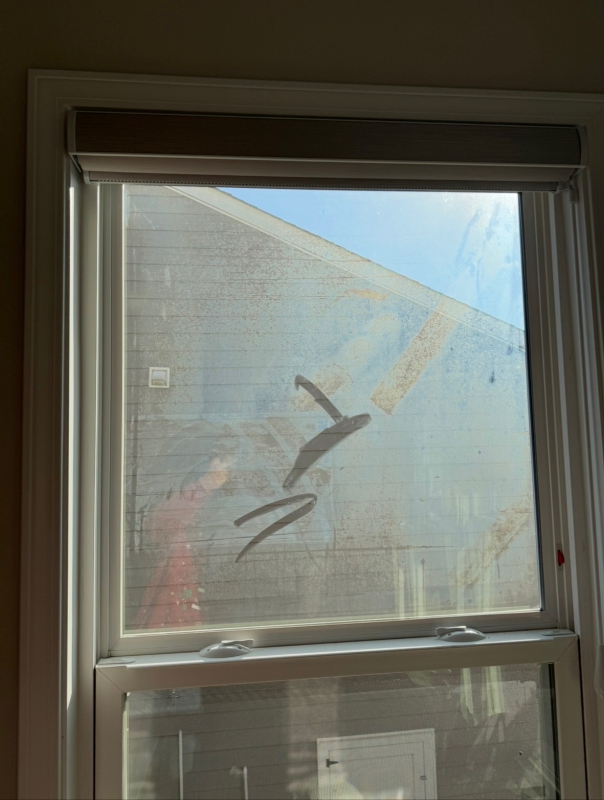 Tall window with hard water spots — before cleaning